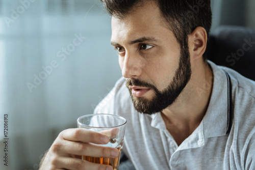 Depressed good looking man drinking whisky