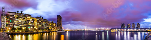 Panorama view of a beautiful view of docklands and The Bolte Bridge with a cloudy sky and twilight in Melbourne Australia. © MrForever