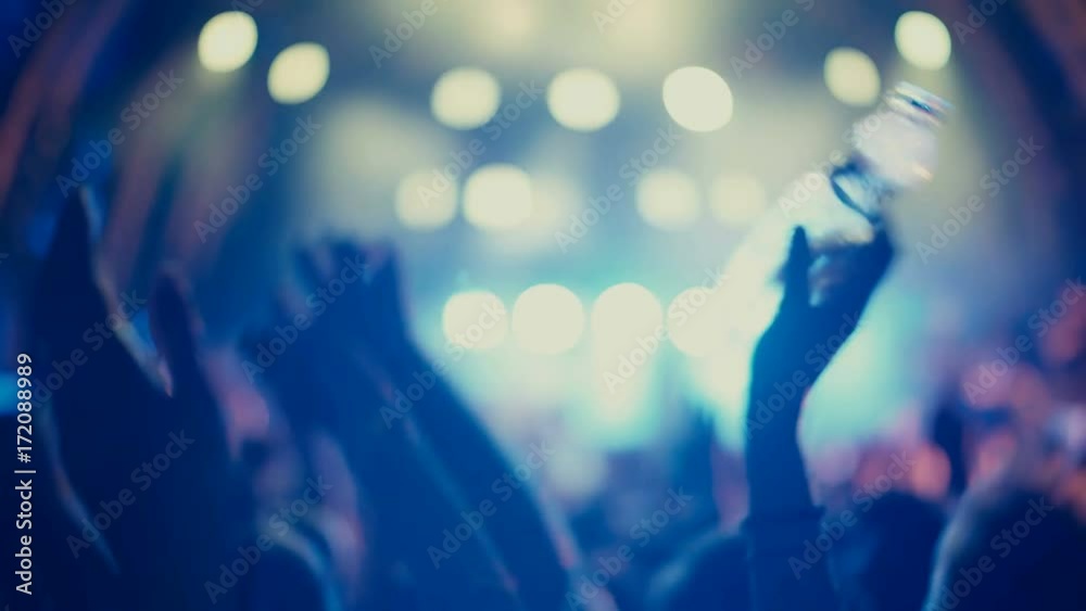 4K UHD Night rock concert front row crowd cheering hands in air.Series of real time close up shots from a night rock concert.People clap their hands in unison against the strobing stage lights.