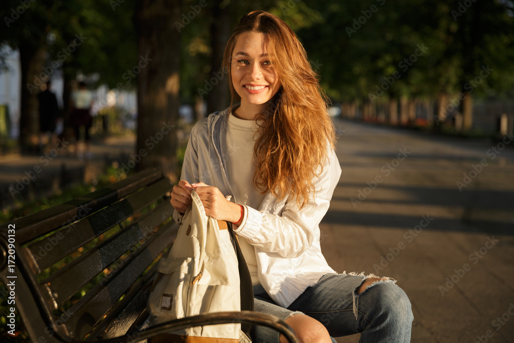 Side view of smiling brunette woman in autumn clothes