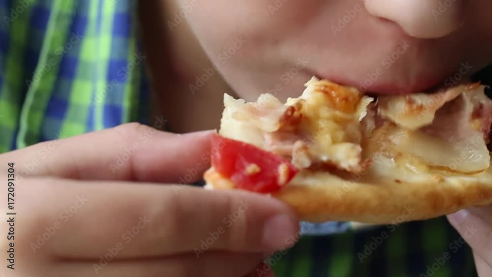 Closeup view of white little kid eating pizza at fastfood restaurant. Real time full hd video footage. Closeup view of white little kid eating pizza at fastfood restaurant. Real time full hd video footage.