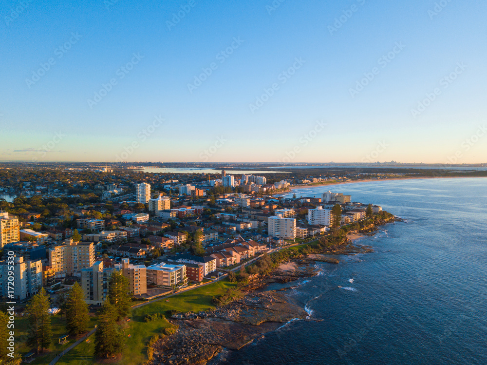 Aerial view of Cronulla coastline with clear blue sky.