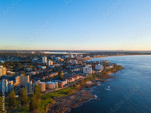 Aerial view of Cronulla coastline with clear blue sky.