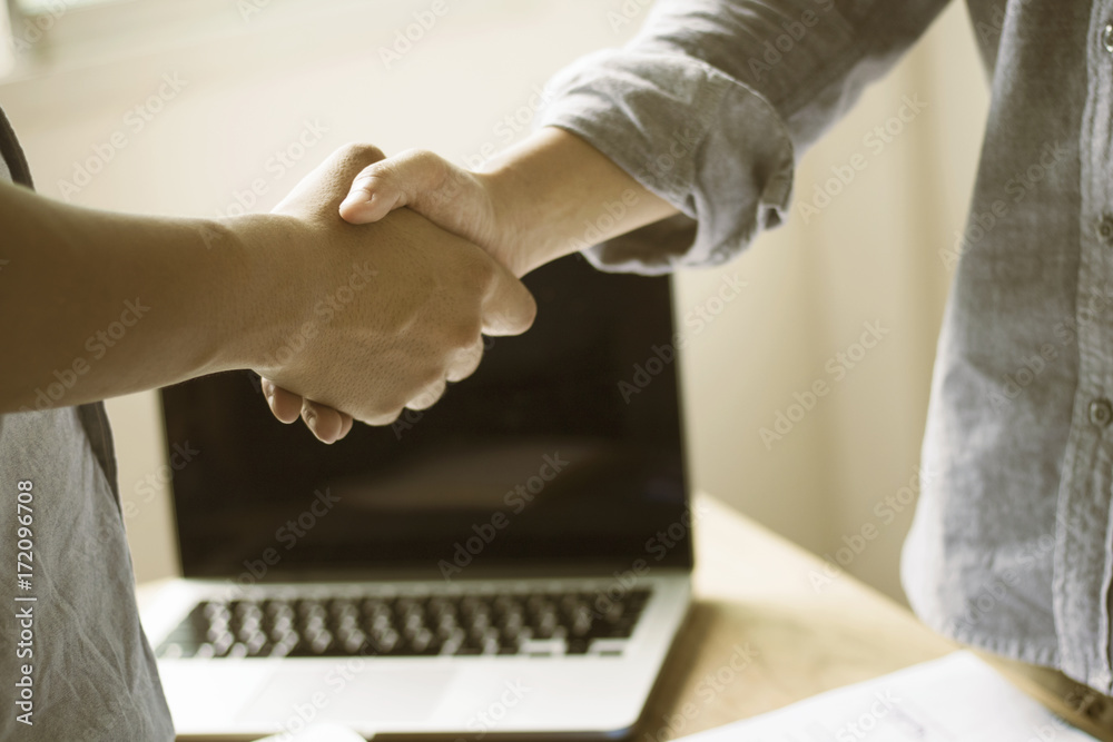 businessman shaking hand in working place or office, concept as teamwork and cooperation in success business