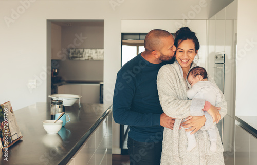 Lovely young family of three in kitchen