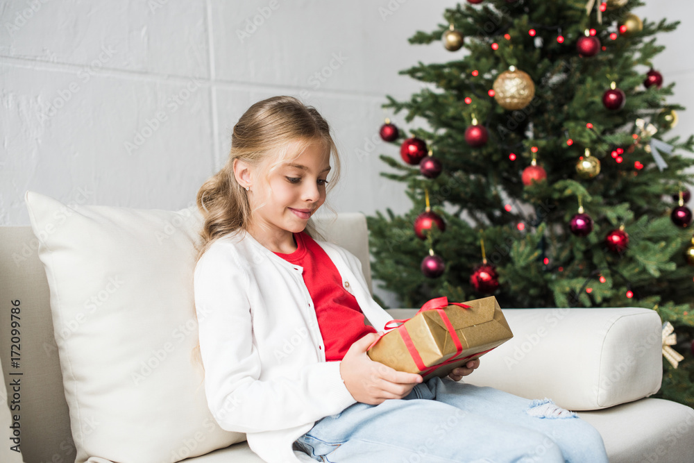 kid holding christmas present kid holding christmas present