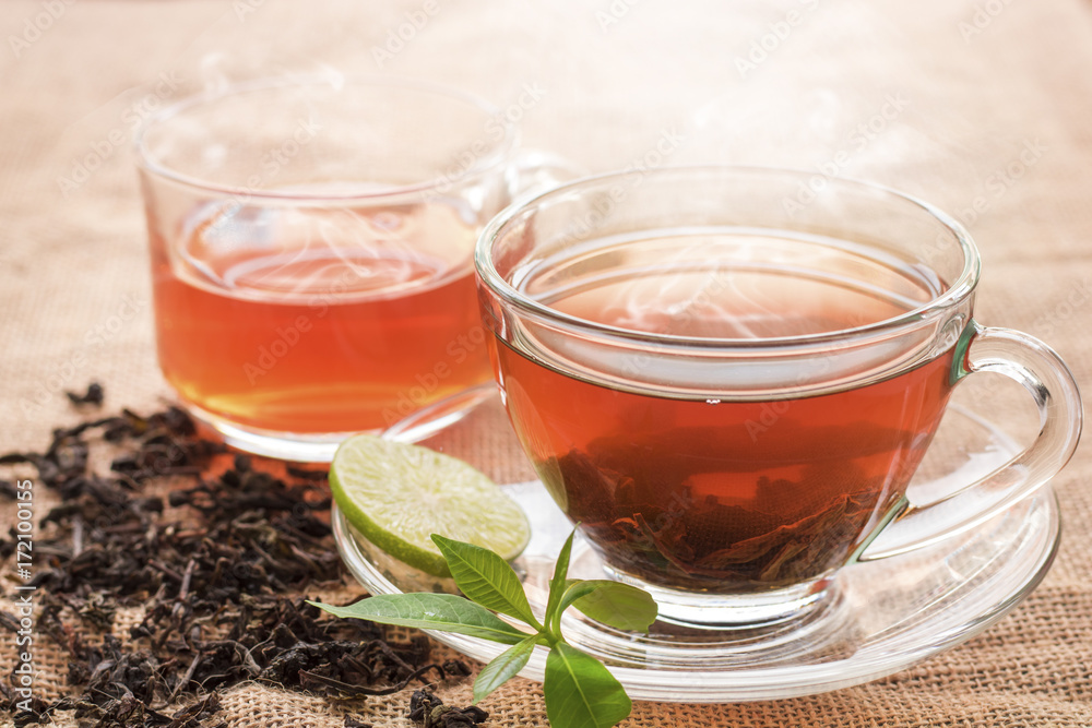 Hot tea of cup with slice of lemon on hemp sack for break fast and drinking time in morning Hot tea of cup with slice of lemon on hemp sack for break fast and drinking time in morning