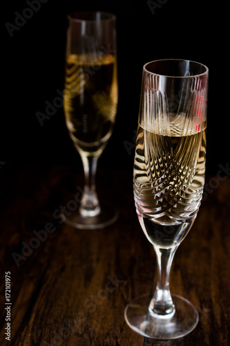 Champagne glasses on dark wooden surface. © Alp Aksoy