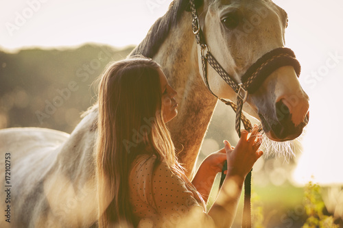 Konstfotografi Woman with her horse at sunset, autumn scene