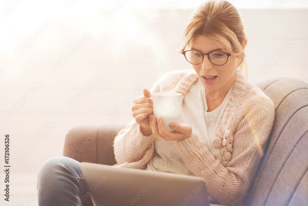 Pleasant nice woman having tea