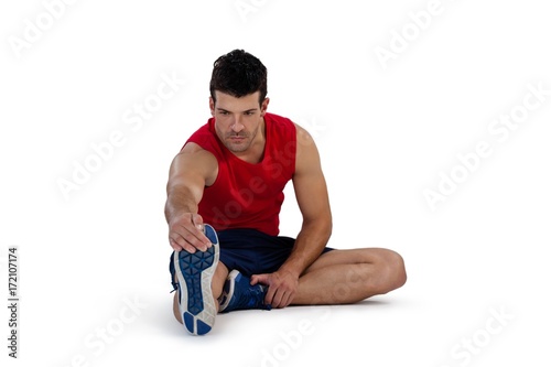 Full length of sports person stretching legs while exercising