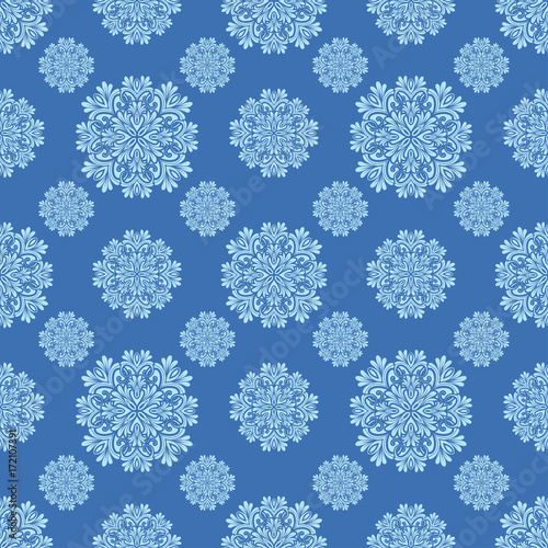 Christmas seamless pattern with white snowflakes on blue background. 