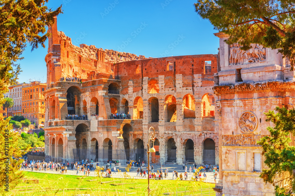 Beautiful landscape of the Colosseum in Rome- one of wonders of the world  in the morning time with tourists near him.