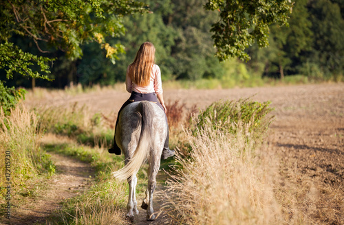 Woman riding a horse on farm at countryside © leszekglasner