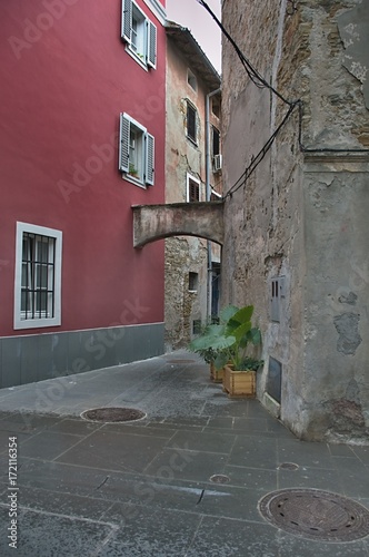 Fototapeta Naklejka Na Ścianę i Meble -  A small street in one  old Mediterranean Town - contrast repaired and old plaster