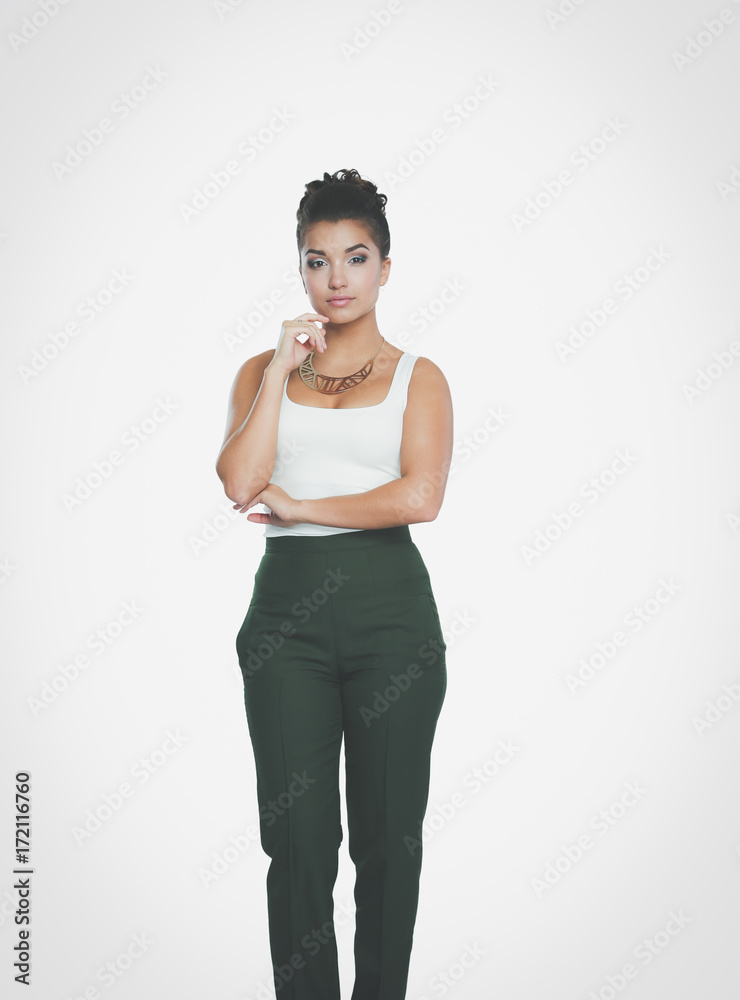 Young woman standing, isolated on gray background