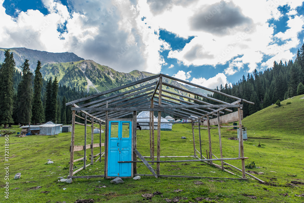 House without walls and blue door in Kyrgyzstan