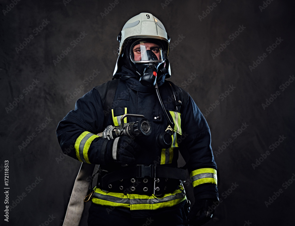 Firefighter dressed in uniform and an oxygen mask. Firefighter dressed in uniform and an oxygen mask.