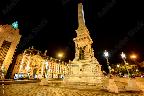 A popular Obelisk in Praca dos Restauradores or Restoration Square in honor of Portuguese Independence from Spain in Lisbon downtown, Portugal. Spectacular urban night landscape. © bennymarty