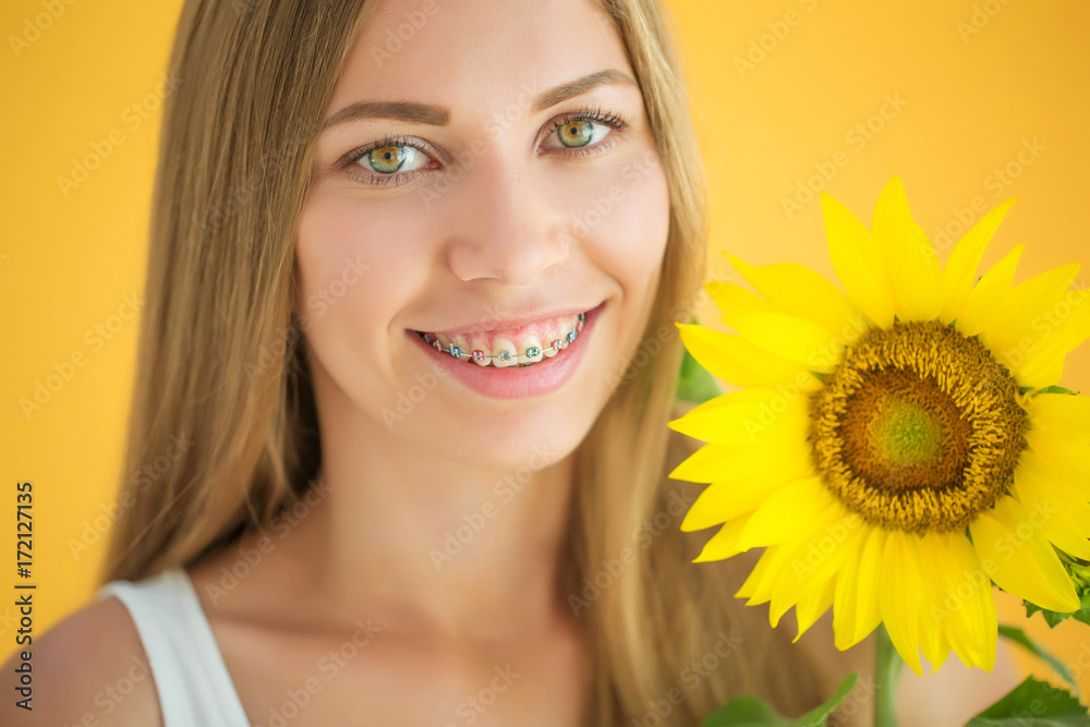 A woman is wearing braces 