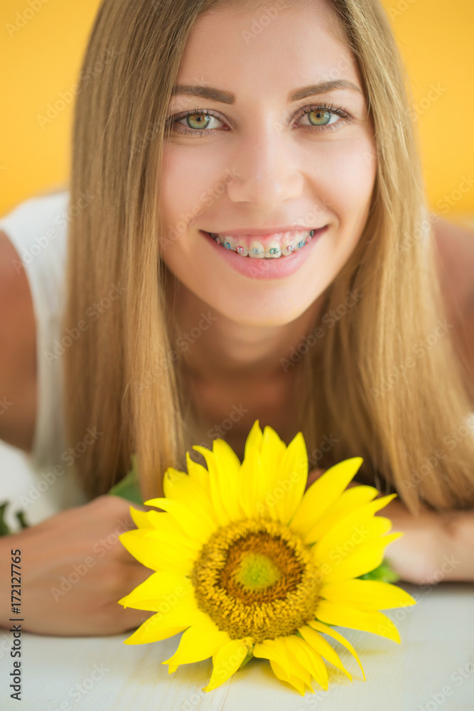 A woman is wearing braces 
