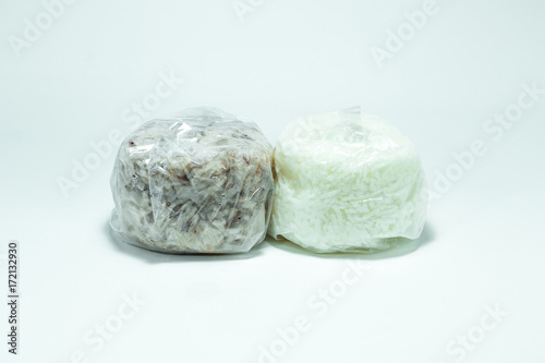 Brown rice and jasmine rice in a plastic bag on white background.