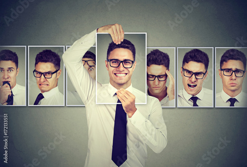 Masked young man in glasses expressing different emotions photo