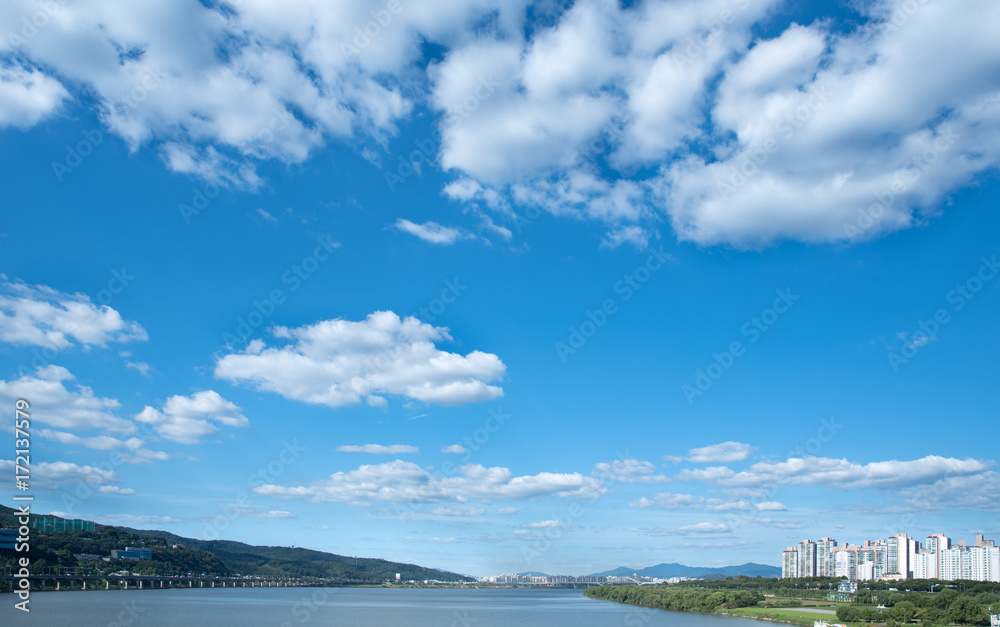 Blue sky with river and town.
