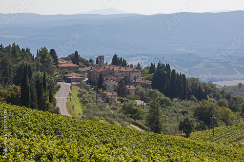 Traditional village is surrounded by picturesque hills in the Chianti region, Tuscany, Italy