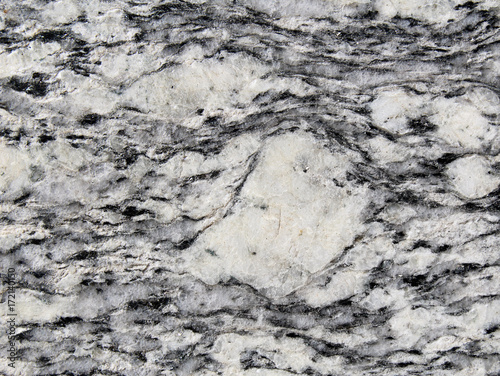 Porphyroclast surrounded by foliation in metamorphic rock