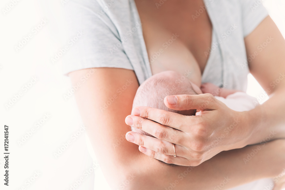 Mother breastfeeding newborn baby at home. Mother breastfeeding newborn baby at home.