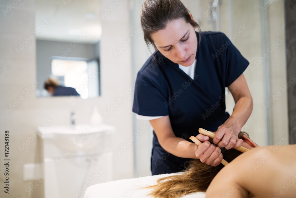 Masseur massaging masseuse at wellness resort Masseur massaging masseuse at wellness resort