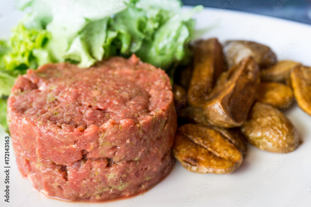 tasty Steak tartare (Raw beef) - classic steak tartare on white plate tasty Steak tartare (Raw beef) - classic steak tartare on white plate