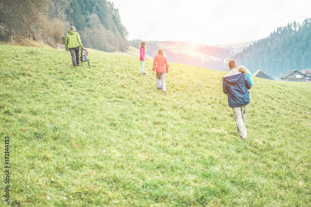 Large family having trekking walking day in switzerland mountains in sunny day Large family having trekking walking day in switzerland mountains in sunny day