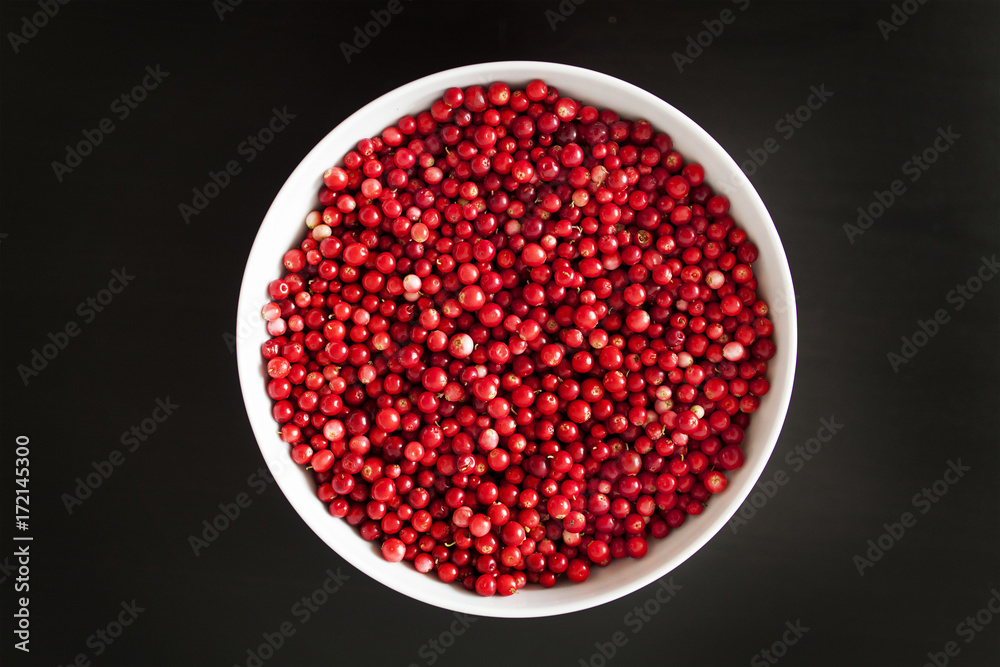 cranberries in bowl on black background cranberries in bowl on black background