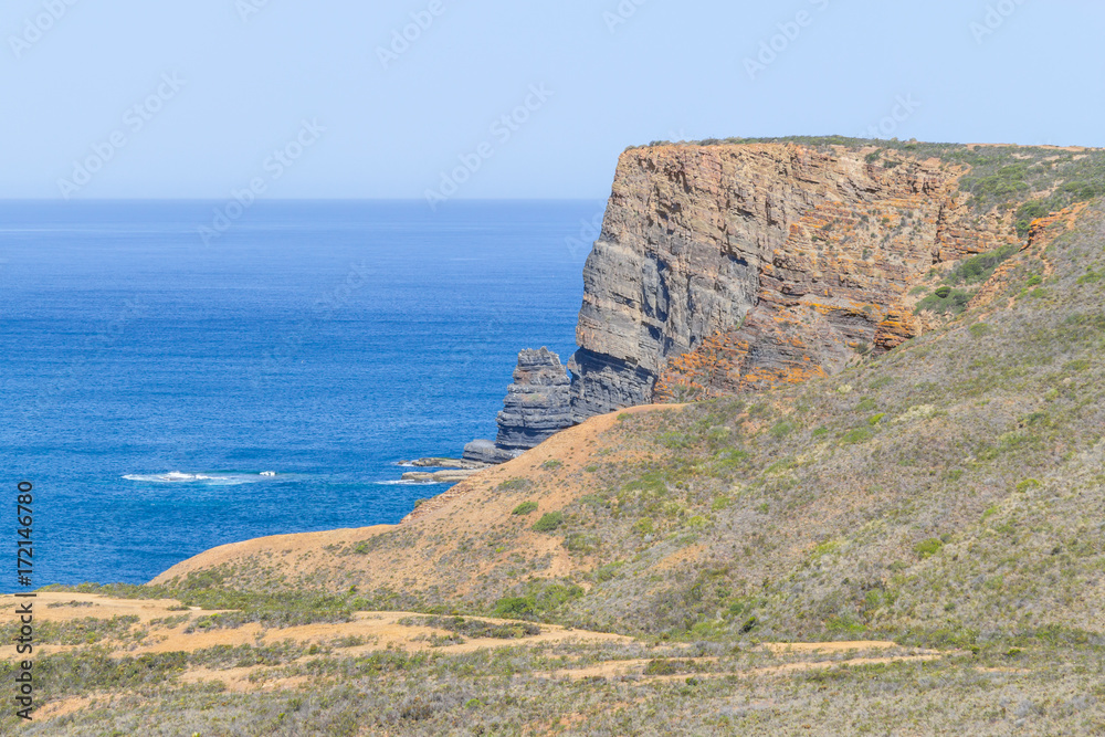Cliffs, ocean, mountains and vegetation in Arrifana Cliffs, ocean, mountains and vegetation in Arrifana