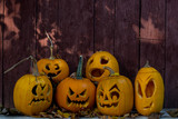 Halloween pumpkins on wooden rustic background with copy space