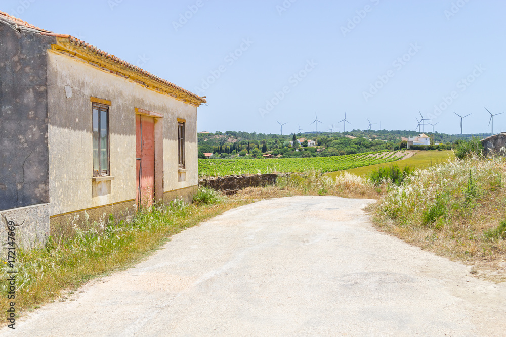 Old Portuguese house, Trail and wind farm in the mountain Old Portuguese house, Trail and wind farm in the mountain