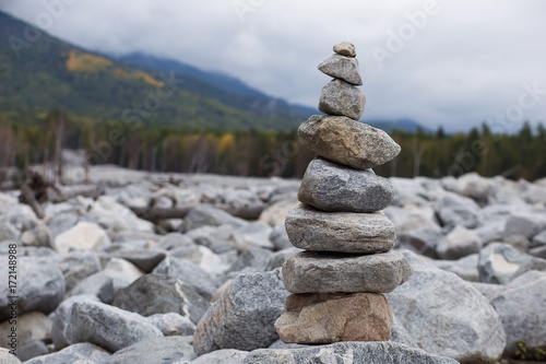 pyramid of stones on a background of forest and mountains.