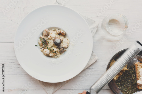 Wild mushrooms risotto with rosemary and parmesan, italian cuisine © Prostock-studio