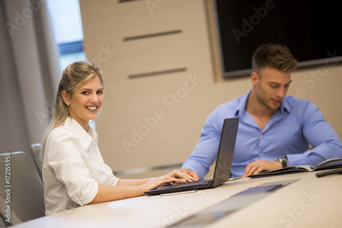 Young man and woman working together in an modern office
