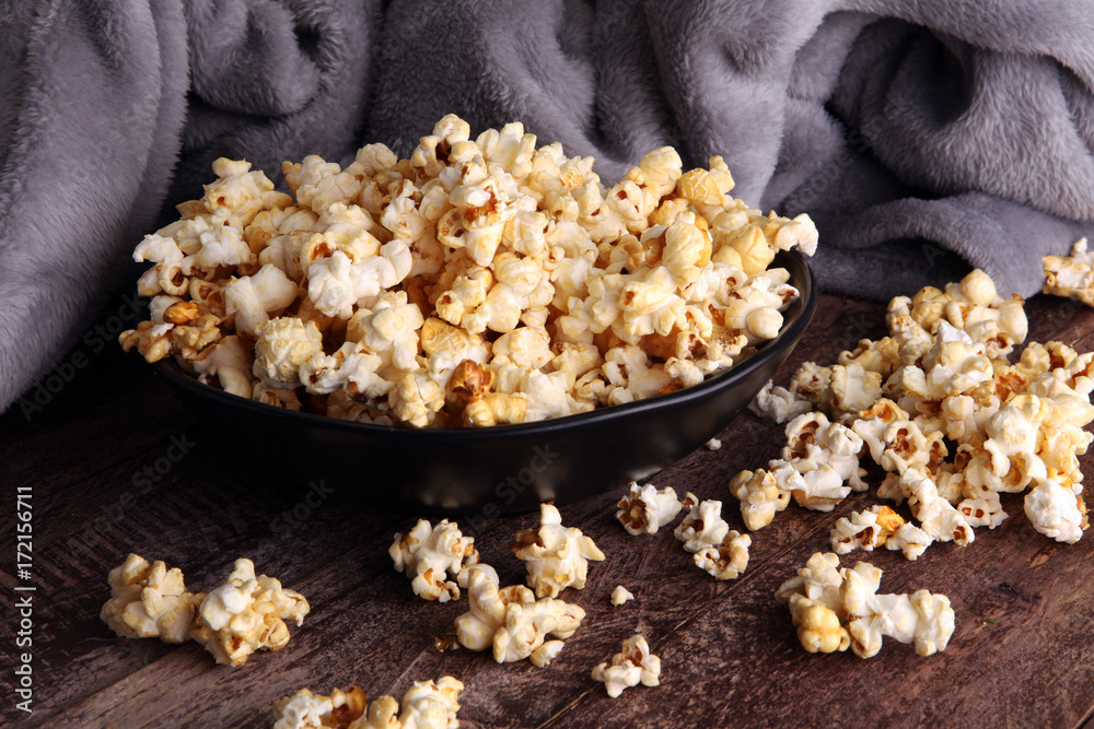 Salt popcorn or sweet popcorn in bowl on the wooden table Salt popcorn or sweet popcorn in bowl on the wooden table