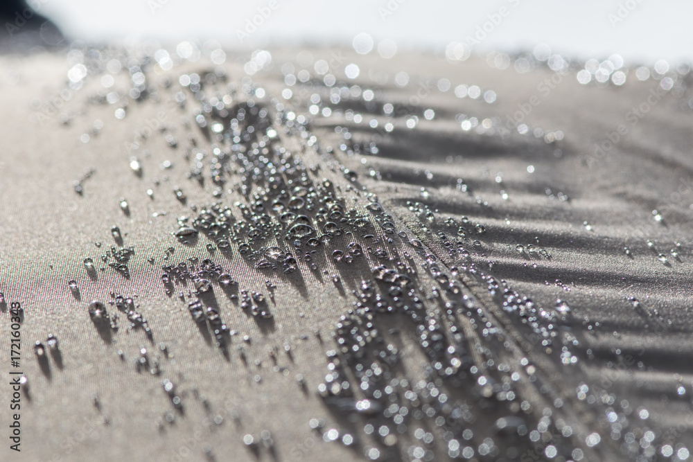 Hydrophobic rain water droplets forming beads on a waterproof parasol  umbrella surface. Stock Photo | Adobe Stock