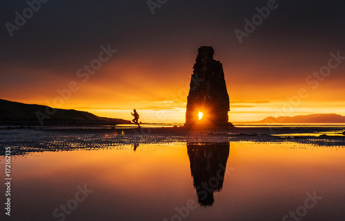 Is a spectacular rock in the sea on the Northern coast of Iceland. On this photo Hvitserkur reflects in the sea water after the midnight sunset