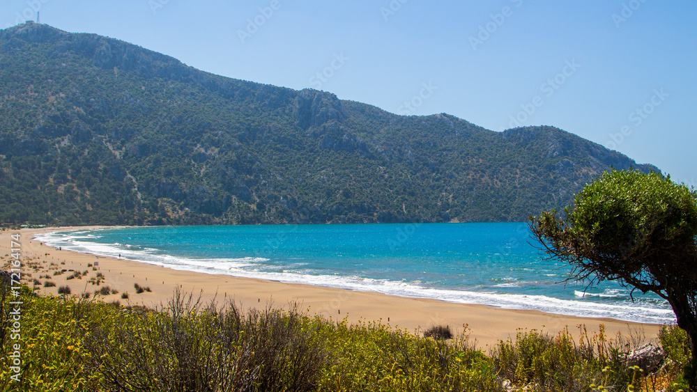 Naklejka premium View of the beach from the cliff. Beautiful blue sea. Incredible landscape of the coast. Turkey