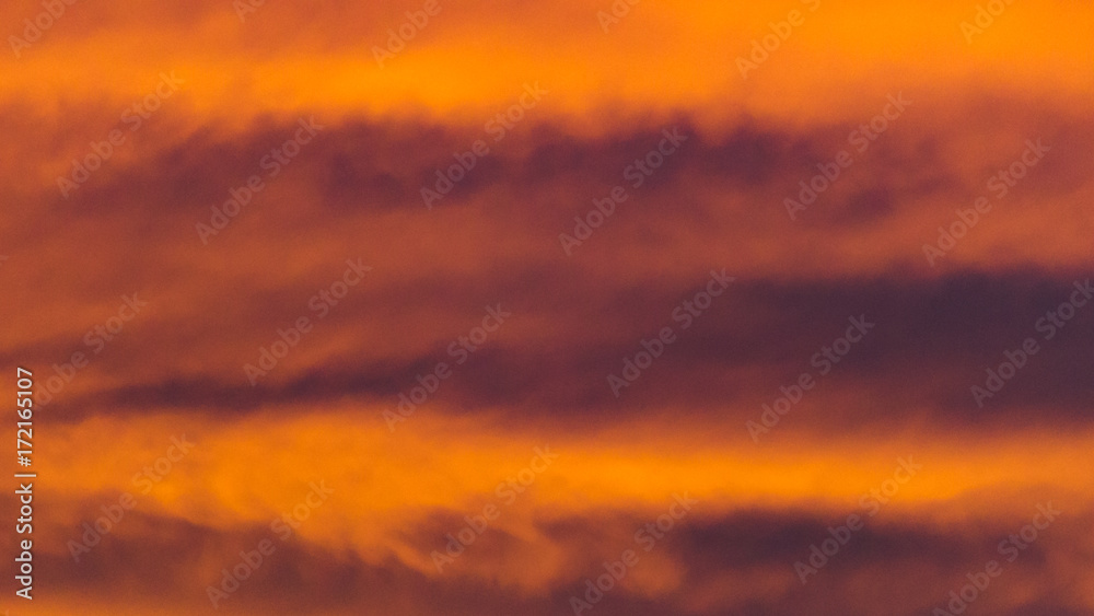 Fototapeta premium Background texture of dramatic sunset sky with orange clouds after thunderstorm