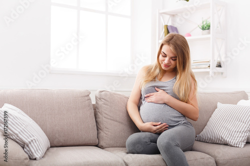 Thoughtful pregnant woman dreaming about child