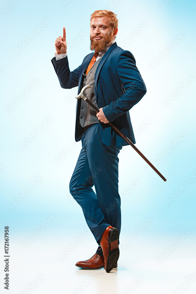 The barded man in a suit holding cane. The barded man in a suit holding cane.