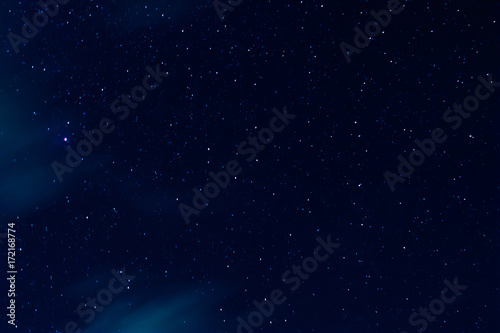 Night sky with stars and clouds in motion
