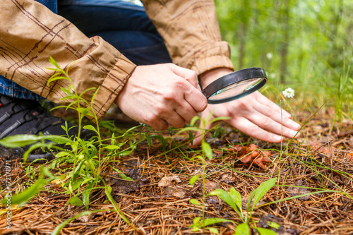 Photo of biologist with magnifying glass photo